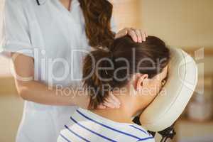 Young woman getting massage in chair