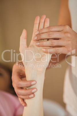 Young woman getting hand massage