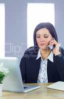 Businesswoman on a call at her desk