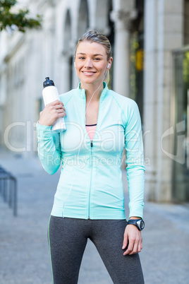 A beautiful woman holding a bottle of water