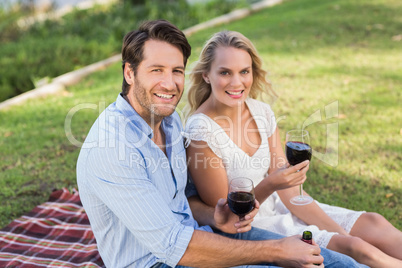 Cute couple on date holding red wine glasses