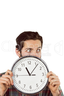 Handsome hipster showing a clock