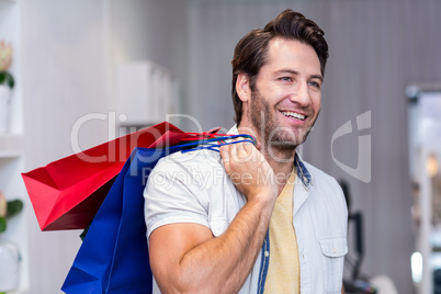 Smiling man with shopping bags