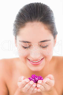 Smiling pretty brunette with flowers