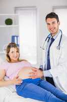 Portrait of smiling doctor and his pregnant patient