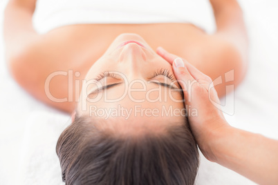 Attractive woman receiving head massage at spa center