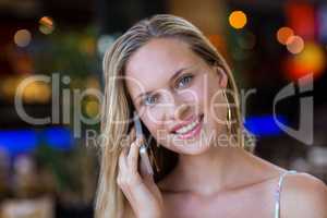 Smiling attractive woman phoning with smartphone