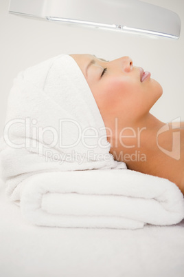 Woman lying on massage table at spa