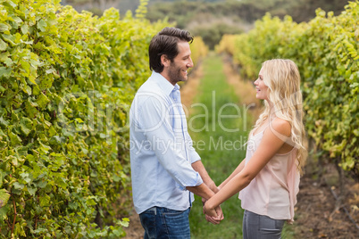 Young happy couple holding hands