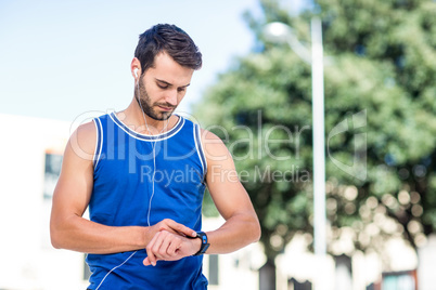 An handsome athlete using his phone