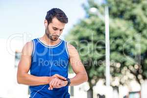 An handsome athlete using his phone