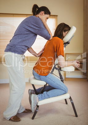 Young woman getting massage in chair