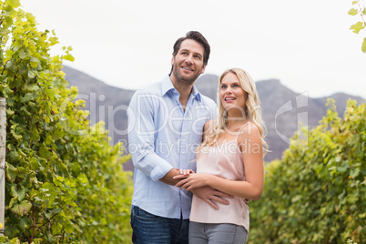 Young happy couple smiling and looking in the distance