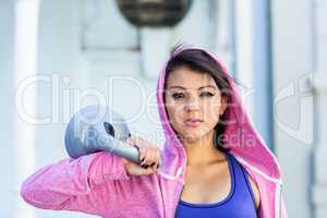 Portrait of athletic woman holding kettlebell