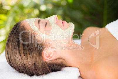 Attractive woman having white cream on her face