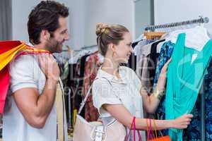 Smiling couple browsing clothes