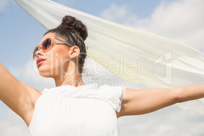 Stylish woman holding her scarf