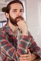 Hipster businessman thinking at his desk