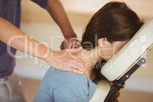 Young woman getting massage in chair