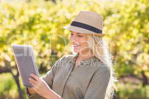 Smiling blonde woman using a tablet