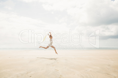 Stylish woman leaping with scarf