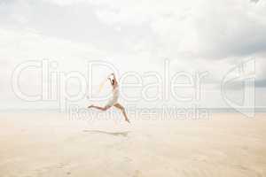 Stylish woman leaping with scarf