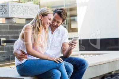 Happy couple sitting and laughing together