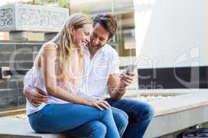 Happy couple sitting and laughing together