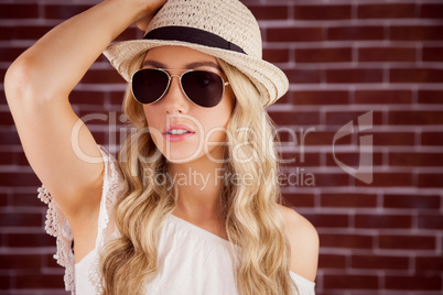 Gorgeous blonde hipster posing with straw hat