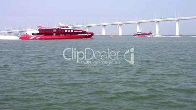 Jetfoils entering and leaving Macau with view of Friendship bridge