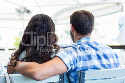 Cute couple sitting outside a cafe