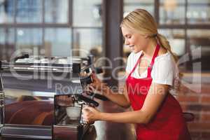 A pretty barista preparing coffee