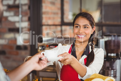 Smiling waitress serving a client