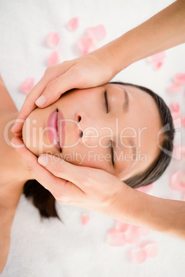 Attractive young woman receiving facial massage