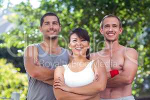 Smiling extreme athletes standing with arms crossed