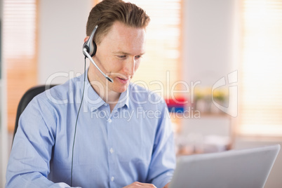 Casual businessman using headset on a call