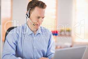 Casual businessman using headset on a call