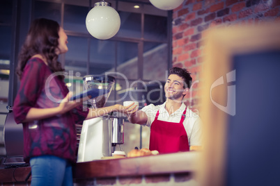 Smiling waiter serving a client