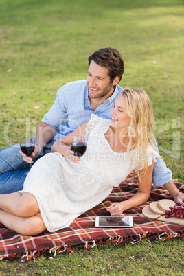 Cute couple on date holding red wine glasses