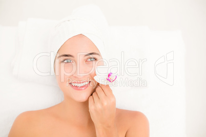 Close up of a beautiful young woman holding flower