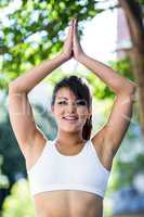 Portrait of smiling athletic woman doing yoga
