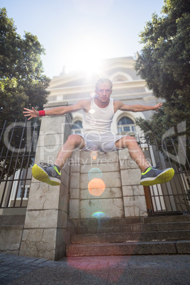 Extreme athlete jumping in the air in front of a building