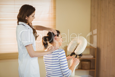 Young woman getting massage in chair