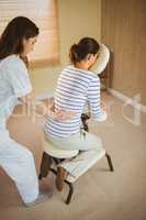 Young woman getting massage in chair