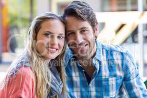 Smiling couple having tea in a cafe