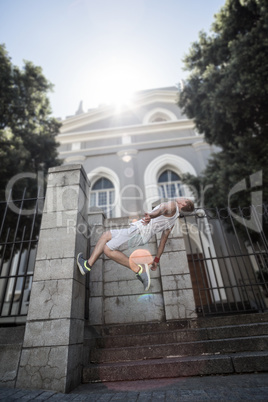 Extreme athlete doing a backflip in front of a building