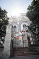 Extreme athlete doing a backflip in front of a building