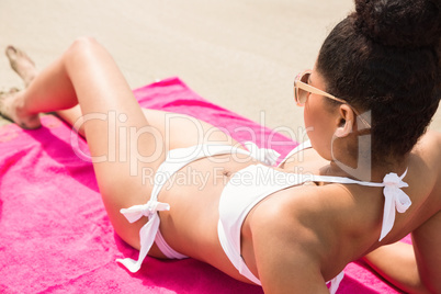 Smiling woman sunbathing on towel