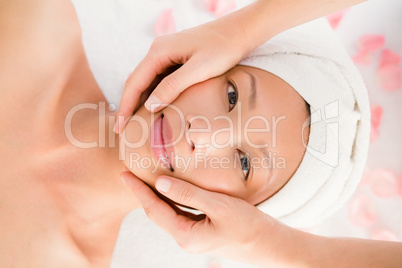 Attractive young woman receiving facial massage