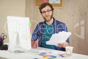 Happy hipster working at his desk